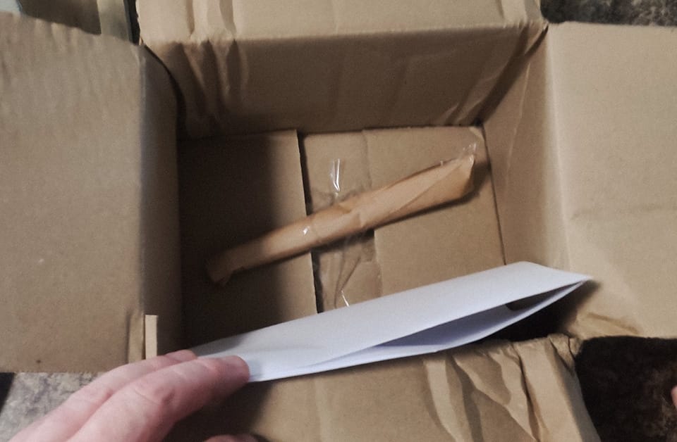 A tiny package taped to the bottom of the box