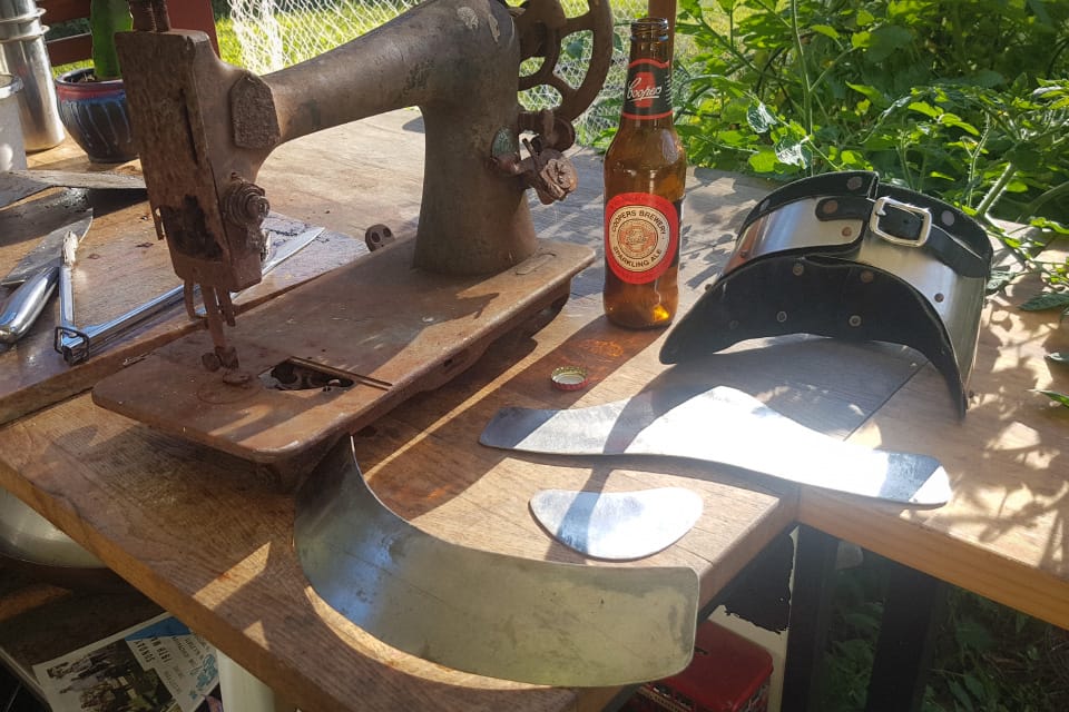Bending the stainless pieces on an old singer machine body