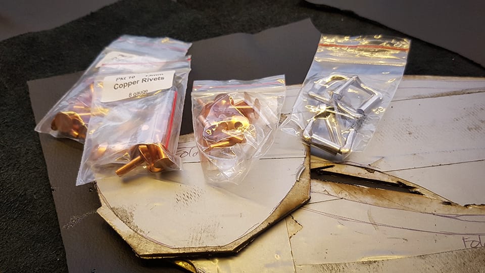 Copper rivets and buckles and the marked out pieces of stainless