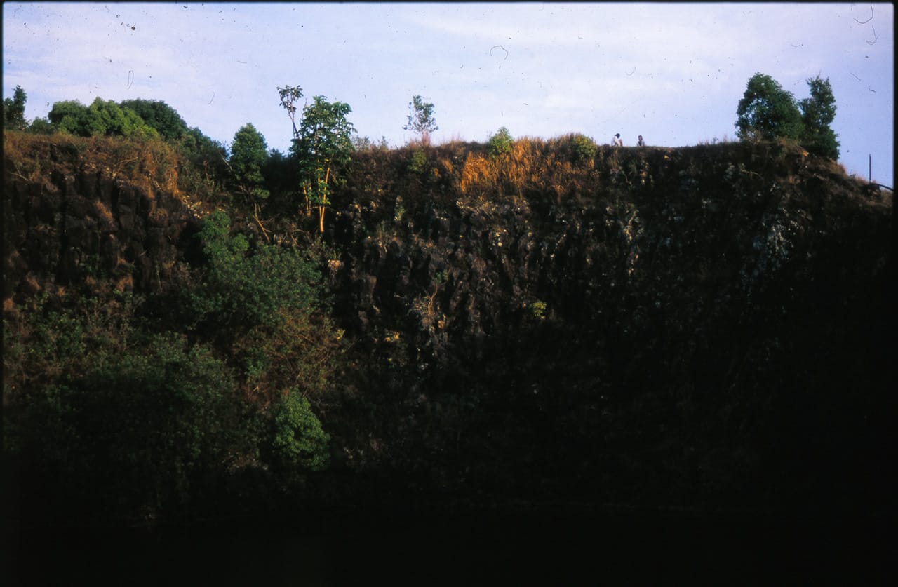 2 people sit atop the cliffs at the Island Quarry - Boredoms - Boadrum111 - Byron Bay November 2011