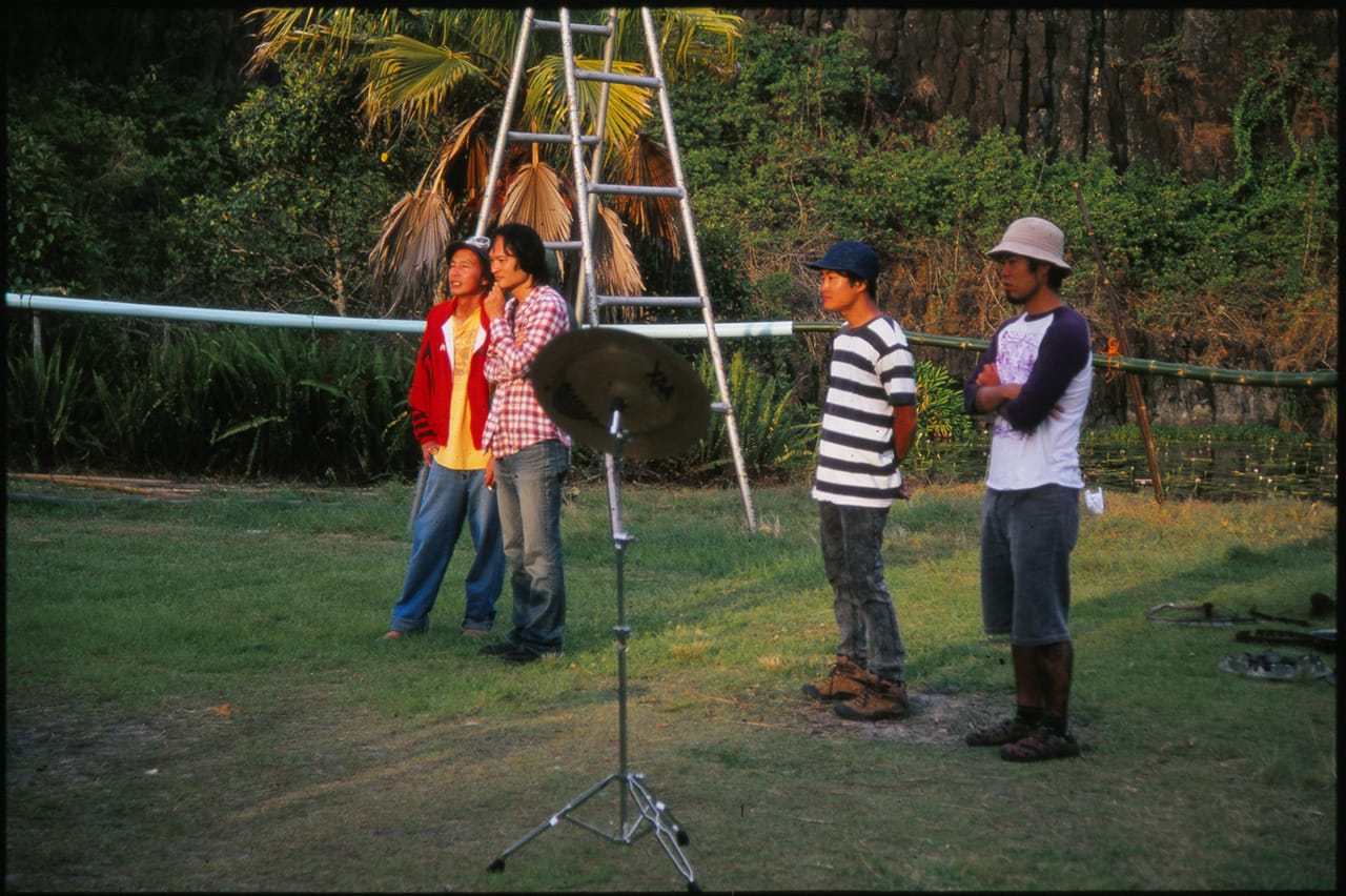 4 men watch the sunset at Boredoms - Boadrum111 - Byron Bay November 2011